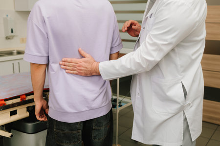 Physical exam with urologist performing renal percussion for kidney painの写真素材