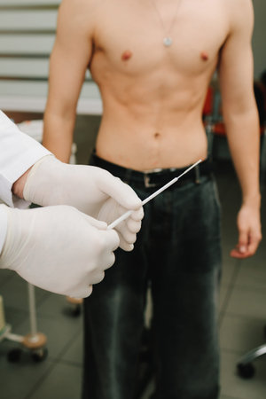 Urologist prepares for urology exam using sterile swabの写真素材