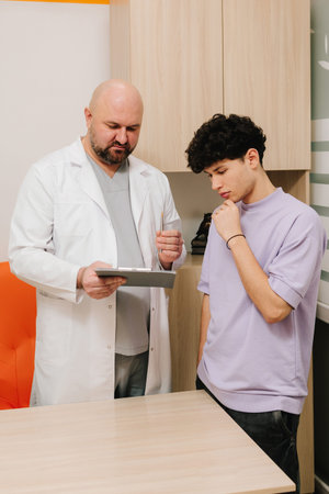 Patient meeting urologist to evaluate urinary problems and health historyの写真素材