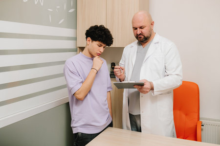 Urologist consults a patient to discuss urinary symptoms and medical historyの写真素材