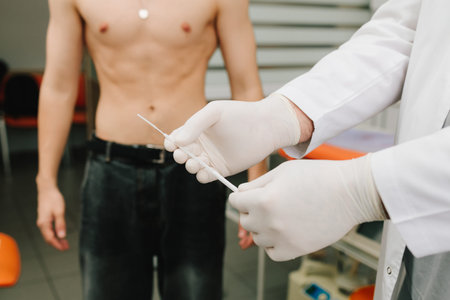 Urologist holding sterile swab preparing for genitourinary examinationの写真素材