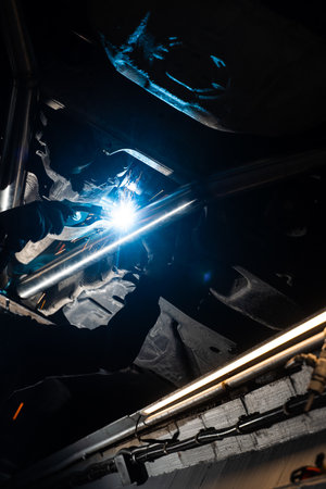 Custom exhaust installation with MIG welding on vehicle exhaust pipes