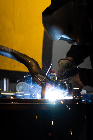 Industrial welding with flux-coated electrode and bright sparks flying