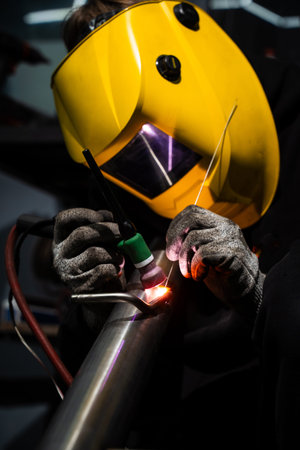 Argon TIG welding by professional on automotive custom exhaust pipe