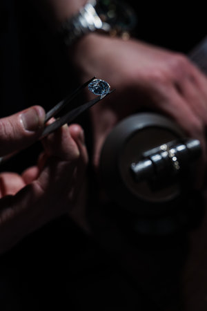 Close up of big diamond being examined over jewelry ring