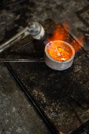 Manual gold melting using torch before casting jewelry