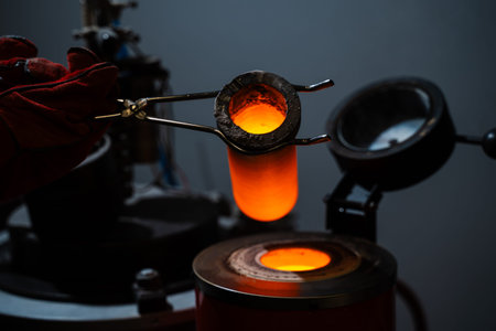 Gold melting in a crucible before casting jewelry