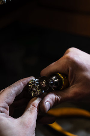 Jeweler polishing a ring to achieve a smooth, shiny surfaceの写真素材