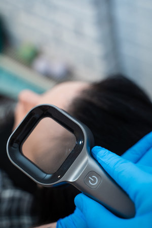 Illuminated magnifier used by trichologist for detailed scalp examination
