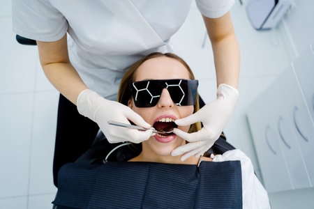 Dentist performs dental checkup examining teeth and maintaining oral healthの写真素材