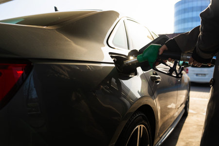 Close-up of fuel pump nozzle in car fuel tankの写真素材