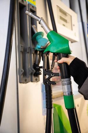 Close-up of gasoline nozzle filling car fuel tankの写真素材