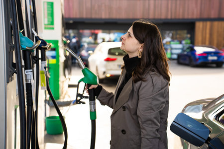 Checking fuel price while filling car with gasoline