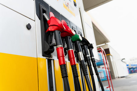 Petrol pump nozzles at service station. Fuel pump nozzles at gasoline station