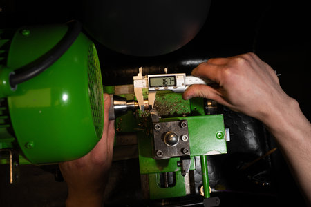 Jeweler measures a ring using a precision caliper to determine exact dimensions and sizing