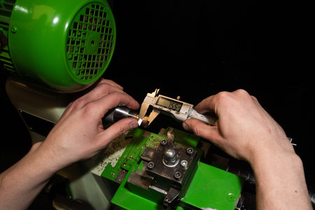 Jeweler measures a ring using a precision caliper to determine exact dimensions and sizing
