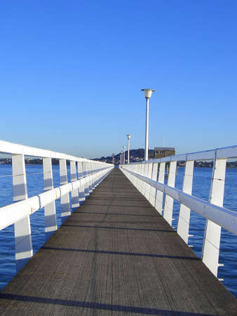 A long fishing wharf on a bright sunny dayの写真素材