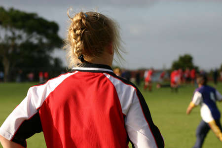 Girl waiting to play soccer for her teamの写真素材