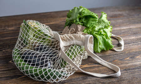String bag on a wooden table. Concept of eco-friendly behavior, the use of reusable bags and care for the environment. Top viewの写真素材