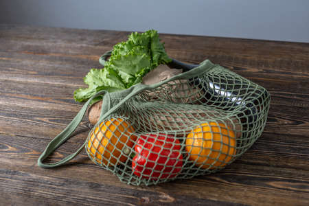 String bag on a wooden table. Concept of eco-friendly behavior, the use of reusable bags and care...