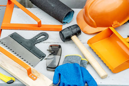 Set of construction tools on aerated concrete blocks on a building site.