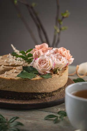 Delicious and beautiful raw cake decorated with tenderness fresh flowers. Concept of romantic mood and spring atmosphere.の写真素材