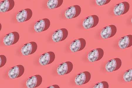 A pattern of shiny fashionable eggs on a pink background. Concept of Easter.の写真素材