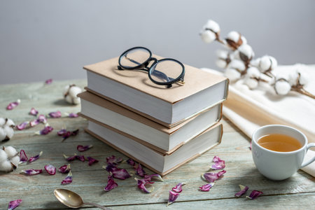 A neat stack of books with craft paper covers on a blue wooden table. Concept of reading and celebrating books.の写真素材