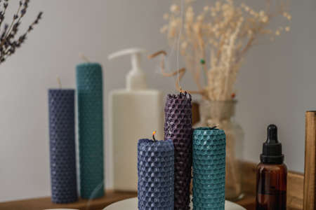 Extinguished candles and cosmetics for care are on the table. The end of aromatherapy, skin care rituals, meditation.の写真素材