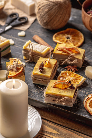 Beautiful natural soap decorated with a slice of orange and star anise. Concept of handmade organic gifts, a useful hobby, a festive atmosphere.の写真素材