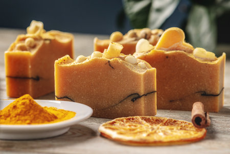 Natural orange soap on the wooden background. Concept of making and using organic eco soaps and...