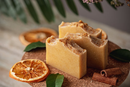 Natural orange soap on the wooden background. Concept of making and using organic eco soaps and cosmetics.の写真素材