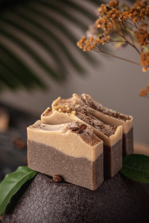 Pieces of fragrant coffee and chocolate soap on a brown background. Concept of natural eco soap and cosmetics.の写真素材