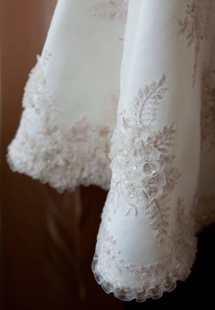 white wedding dress with a fine lacy pattern  fragmentの写真素材