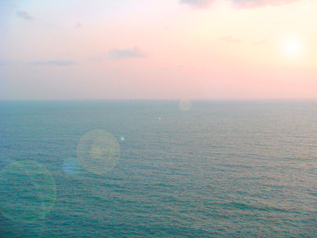 Bright blue sea, clear cloud sky, beautiful mountainの写真素材