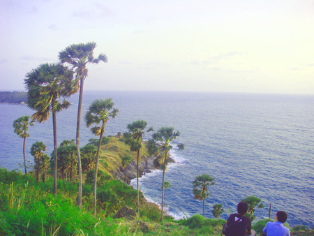 Bright blue sea, clear cloud sky, beautiful mountainの写真素材