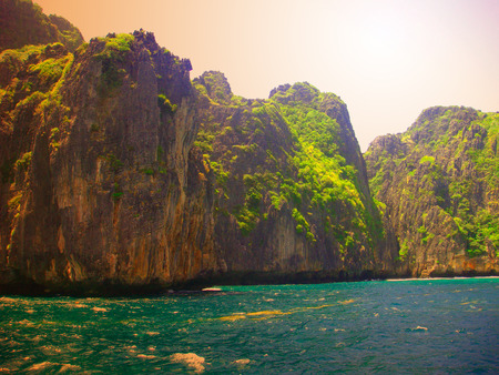 Bright blue sea, clear cloud sky, beautiful mountainの写真素材