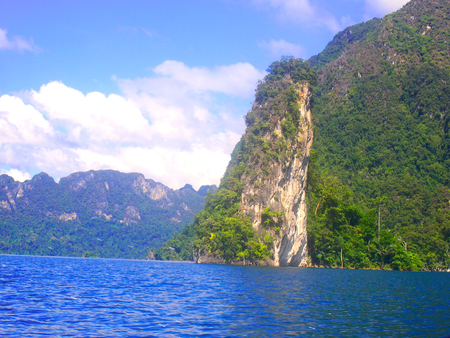 Bright blue sea, clear cloud sky, beautiful mountain