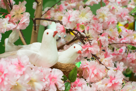 Fake flowers and fake birds are used to decorate the beauty of the place. colorful, green, decoration, gardenの写真素材