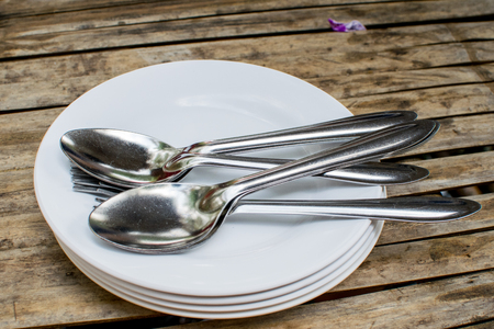 Spoon plate and spoon on dining tableの写真素材
