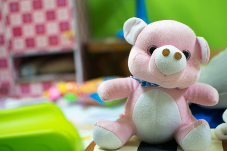 Pink teddy bear placed on the bed.の写真素材