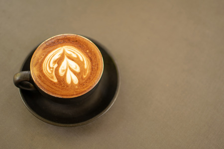 Black coffee cups placed on a gray table.の写真素材