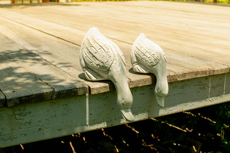Duck statue placed on wooden floor.の写真素材