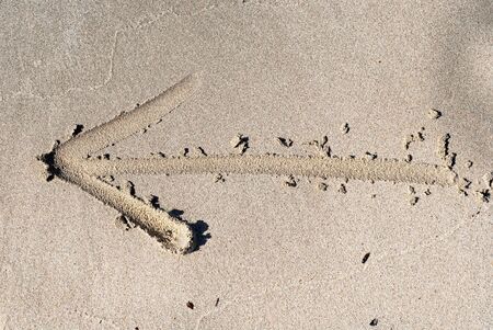 arrow on sandの写真素材