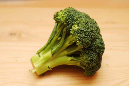 Broccoli on wooden plate. Soft focus on broccoli.の写真素材