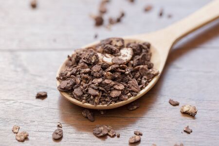 granola in wooden spoon on the table