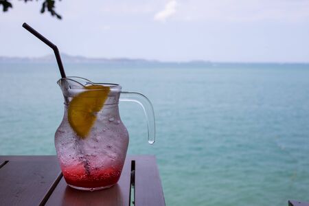 fresh soft drink in a grass with see in backgroundの写真素材