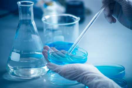 Laboratory beakers, microscope, pipette. Science experiment concept background.の写真素材