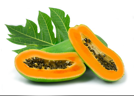whole and half ripe papaya with green leaf isolated on white backgroundの写真素材