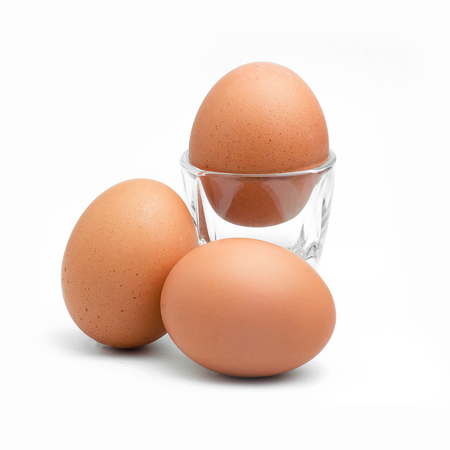 brown chicken egg isolated on whiteの写真素材